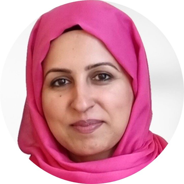 Uzma Asker A woman wearing a pink head scarf smiling to camera.
