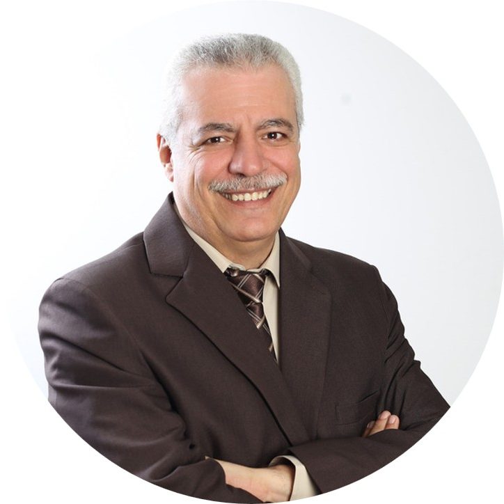 Rami Taweelih A Jordian man with grey hair, wearing a suit and arms folded smiling to camera.